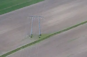 France Prints: Aerial view shows pylon of high-tension electricity power lines in a field in Royan