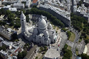 An aerial view shows the Sacre Coeur Basilica and rooftops of residential buildings
