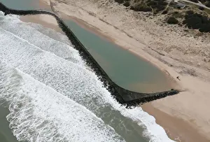 Coastline Prints: An aerial view shows sea walls on the beach that protect sand dunes from erosion along