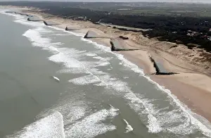 Coastline Prints: An aerial view shows sea walls on the beach that protect sand dunes from erosion along