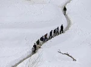Afghan survivors of an avalanche walk in the Abdullah Khil village of the Dara district Afghan survivors of an avalanche walk in the Abdullah Khil village of the Dara district