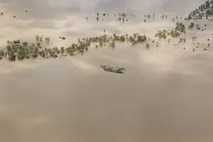 Prints of Agricultural machinery is seen on an isolated island surrounded by flood waters near the town of Emerald in Australias state of Queensland January 2, 2011 Australia Prints: Agricultural machinery is seen on an isolated island surrounded by flood waters near