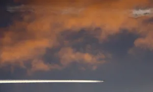 An aircraft flies above Russias Siberian city of Krasnoyarsk during sunset An aircraft flies above Russias Siberian city of Krasnoyarsk during sunset