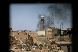 Mideast Prints: Al-Hadba minaret at the Grand Mosque is seen through a building window in the old city of