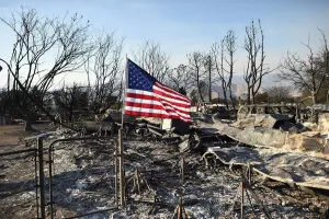 Wildfire Prints: An American flag flies above wreckage at a residence leveled by the Erskine Fire in South
