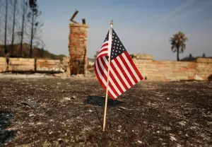 California Prints: An American flag stands in front of a home destroyed after a wildfire tore through Santa