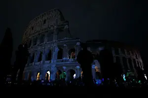 Earth Prints: The ancient Colosseum is seen after the lights were switched off for Earth Hour in Rome