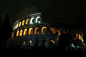 Earth Prints: The ancient Colosseum is seen before the lights are switched off for Earth Hour in Rome