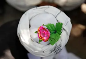 An artificial flower is seen on a turban of a peace marcher as he arrives in Kabul