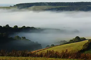 Autumn mists hang over villages and the countryside in the South Downs National Park