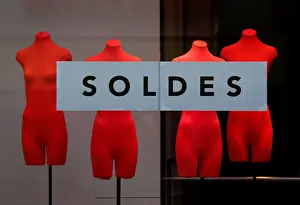 A banner reading Sales is seen on a clothing stores front window during the start of