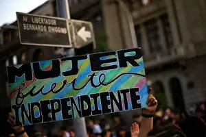 Day Prints: A banner reading Woman, strong and independent is seen during a march to mark