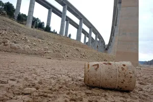 Spain Prints: A barrel lies under freeway bridges on the dried out ground of the partially empty