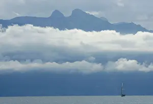 A boat sails on the Leman Lake in front of the misty Ai and Mayen mountains near Lausanne