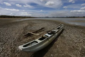 Images Dated 2014 August: A boat is seen on the dried out bottom of a lagoon in Katharagama