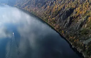 Prints of A boat is seen on the Yenisei River in the Siberian Taiga area outside Krasnoyarsk, Russia October 5, 2017. REUTERS/Ilya Naymushin TPX IMAGES OF THE DAY Russia Prints: A boat is seen on the Yenisei River in the Siberian Taiga area outside Krasnoyarsk