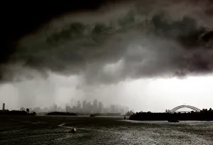 Prints of Boats sail on Sydney harbour as a severe storm hits the city December 13, 2004 Australia Prints: Boats sail on Sydney harbour as a severe storm hits the city