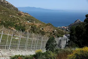 Migrant Prints: The border fence separating Spains northern enclave Ceuta and Morocco is seen from Ceuta