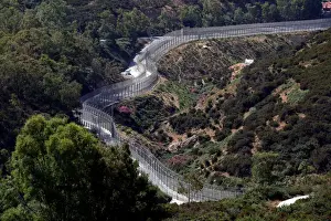 Migrant Prints: The border fence separating Spains northern enclave Ceuta and Morocco is seen from Ceuta