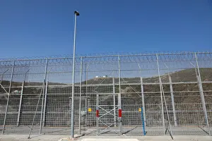 Migrant Prints: The border fence separating Spains northern enclave Ceuta and Morocco is seen from Ceuta