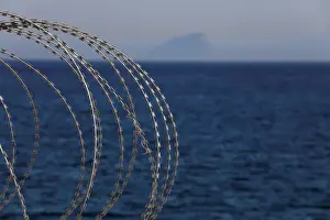 Migrant Prints: The border fence separating Spains northern enclave Ceuta and Morocco is seen from Ceuta