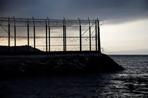 Migrant Prints: The border fence separating Spains northern enclave Ceuta and Morocco is seen from Ceuta