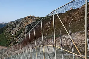 Migrant Prints: The border fence separating Spains northern enclave Ceuta and Morocco is seen from Ceuta