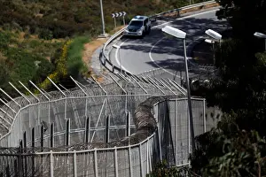 Migrant Prints: The border fence separating Spains northern enclave Ceuta and Morocco is seen from Ceuta
