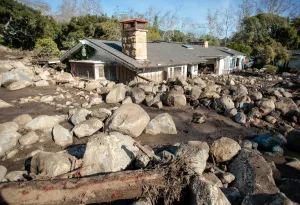 California Prints: Boulders surround a mud-filled property after a mudslide in Montecito, California