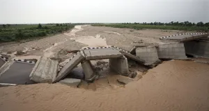 Kashmir Prints: A bridge that was damaged by the flash floods, built over a stream leading to river Tawi