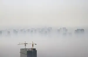 A building under construction is seen amidst smog on a polluted day in Shenyang