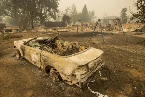 Wildfire Prints: Burned out remains of a vehicle and swing set scorched by the Valley Fire line Jefferson