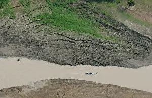 Canoe navigates in what is left of an Amazon River tributary in the Brazilian Amazon