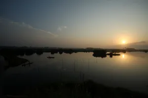 A canoe is seen on the lake by the road to the port of no return in the historic slave A canoe is seen on the lake by the road to the port of no return in the historic slave