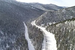 A car drives along the R257 federal highway in the Western Sayan Mountains in Krasnoyarsk
