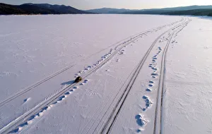 Prints of A car drives along a road on the frozen Yenisei River at sunset, south of Krasnoyarsk, Russia March 21, 2019. REUTERS/Ilya Naymushin TPX IMAGES OF THE DAY - RC16B8B7EBF0 Russia Prints: A car drives along a road on the frozen Yenisei River at sunset, south of Krasnoyarsk