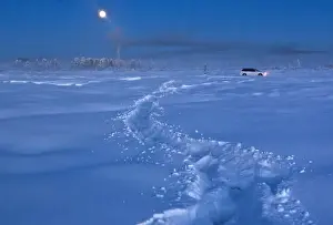 Prints of A car drives through the snow at night near Vostochnaya meteorological station, some 500 km northeast of Yakutsk in the Republic of Sakha, northeast Russia, January 20, 2013 Russia Prints: A car drives through the snow at night near Vostochnaya meteorological station