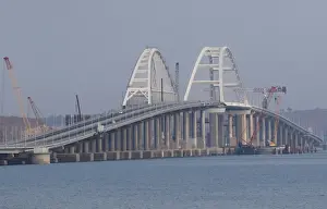 Ukraine Prints: Cars drive along a bridge, which was constructed to connect the Russian mainland with