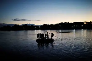 Immigration Prints: Central American migrants cross the Suchiate river into Mexico on a raft as they try to