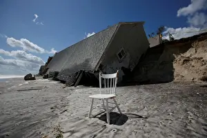 A chair is pictured outside a collapsed coastal house after Hurricane Irma passed