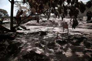 : A chair is seen underneath a tree at an area affected by the eruption of the Fuego