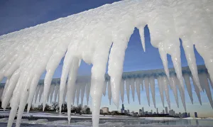 Chicago skyline is framed by icicles in Chicago