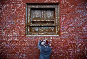 A child writes with chalk on a wall to celebrate Shreepanchami festival at Saraswati