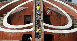 Children play inside one of the instruments of Jantar Mantar in New Delhi