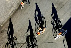 Chinese people ride their bycicles on a sunny autumn day in Beijings city centre