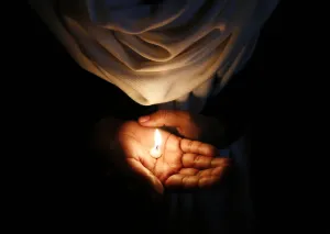 India Prints: A Christian holds a candle during a vigil in New Delhi
