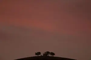 A church is seen atop a mountain during sunset near the town of Kalavrita