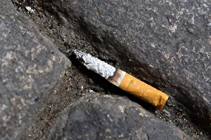 A cigarette butt litters the street in Lyon