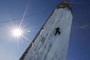 Weather Prints: An climber ascends a silo covered in ice in Cedar Falls