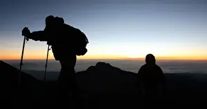 General Prints: Climbers walk up the steep gravel and scree slope leading to the summit of Tanzania s